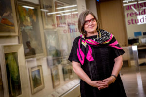 Judy Koke stands in front of case at Art Gallery of Ontario